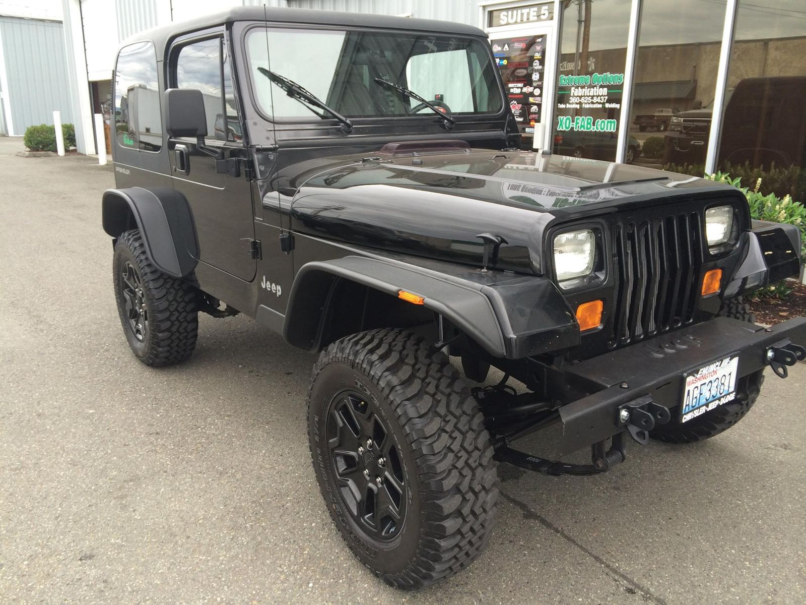 '90 YJ Jeep with lift, wheels, and custom bumper and fenders